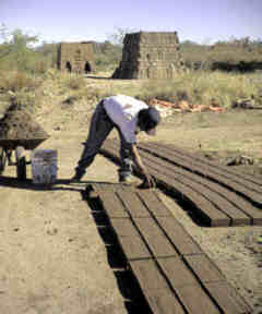 forming bricks, towers in background