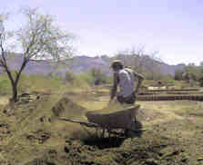 mixing clay in wheelbarrow